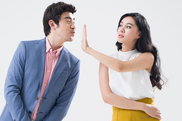 A-woman-rejects-a-mans-kiss